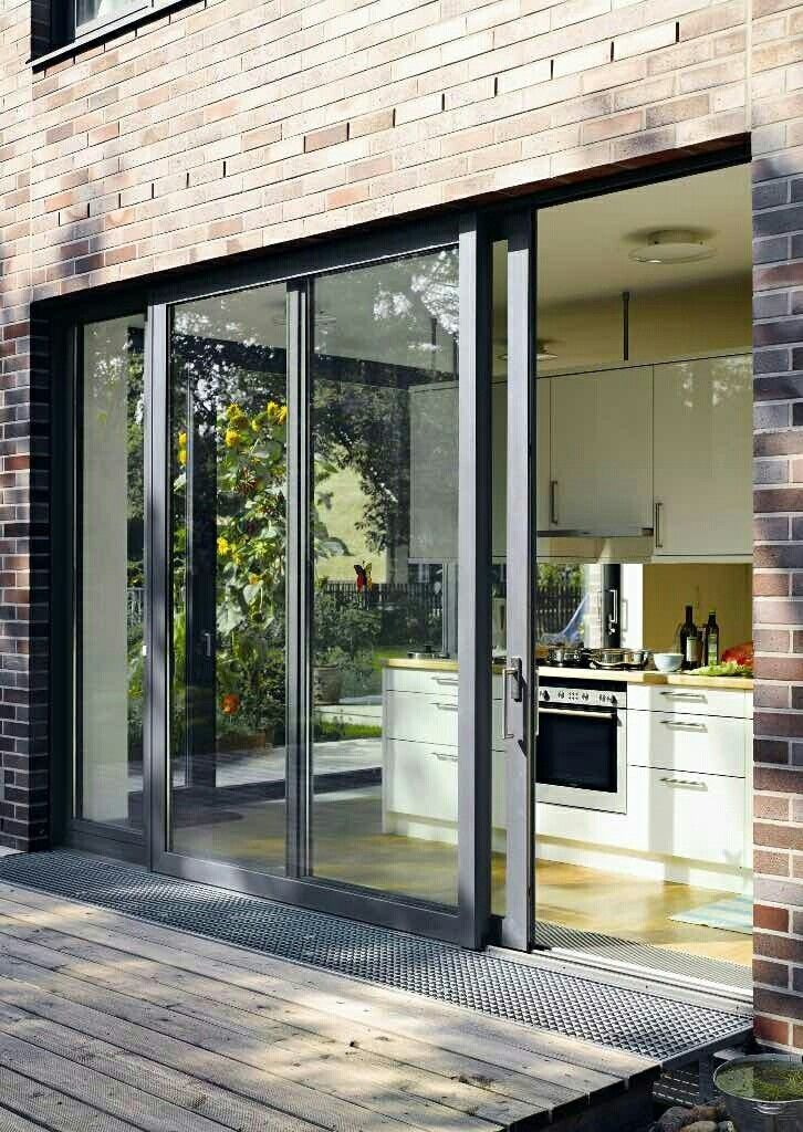 Modern sliding glass patio doors connecting kitchen to backyard