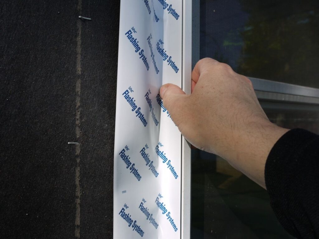 Applying window flashing tape to seal exterior frame edges