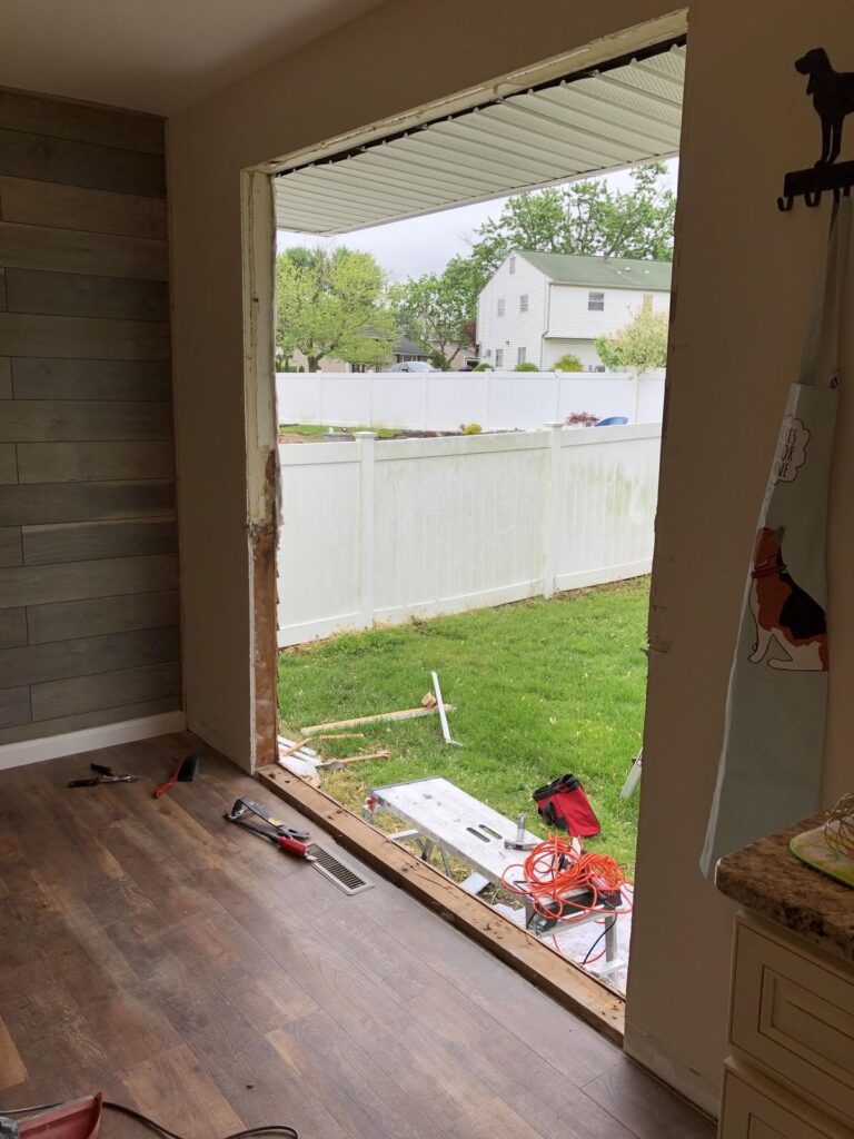 Home patio door removal during renovation showing wall opening