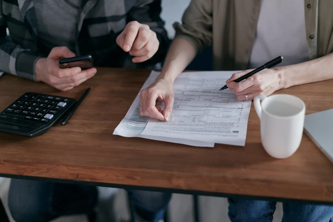 Couple reviewing home energy tax credit paperwork together at desk